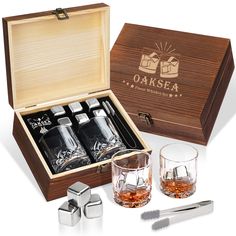 an open wooden box with two shot glasses and one set of silverware in it