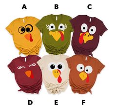 four different colored shirts with cartoon turkey faces on the front and one is red, white, green, yellow