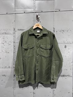 70's OG-107 Fatigue Button Up Shirt- Vietnam War(Army Green)  Great vintage condition. See pictures for condition 15.5x33 . Please review measurements as some vintage items fit smaller than modern sizing. Measurements taken with garment laid flat: 21" across from armpit to armpit 28" length from shoulder to hem 23" sleeve from shoulder to hem Please send a message if you have any questions. Double check measurements and inspect all pictures carefully before purchasing. Orders ship via USPS. All Mens Oxfords, Button Up Shirt, Army Green, Button Downs, Button Up Shirts, Vietnam, Vintage Items, Button Up, Tee Shirts