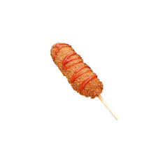 an orange lollipop on a stick with some sauce drizzled over it