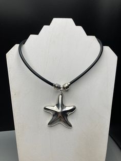 This stunning necklace from Joseph Esposito is a must-have for any jewelry collection. The beautiful starfish pendant is crafted in sterling silver and features a snap closure for easy wear. The necklace is perfect for a variety of occasions. Necklace length 17 inches approx Necklace width 5mm approx Pendant length 2.5 in approx Pendant width 2 1/8 in approx Combined weight 47g The necklace is 17 inches in length and features a solid cord chain type. The black color of the necklace is complement Silver Starfish Charm Pendant Jewelry, Sterling Silver Starfish Charm Pendant Necklace, Sterling Silver Pendant Necklace With Starfish Charm, Adjustable Silver Jewelry With Starfish Charm, Silver Adjustable Starfish Necklace, Adjustable Silver Starfish Jewelry, Silver Starfish Charm Necklace In Sterling Silver, Adjustable Silver Starfish Necklace, Silver Sterling Necklace With Starfish Charm