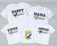 three white shirts with dinosaurs on them and the words daddy, mama, and son