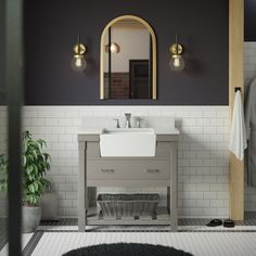 a bathroom with a sink and mirror next to a rug on the floor in front of it