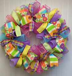 a colorful wreath hanging on the side of a door