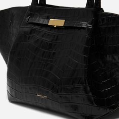 Elevate your accessory game with DeMellier's The Midi New York Croc Effect Bag in Black. This chic and versatile bag is crafted from high-quality leather with an embossed croc effect, offering a perfect blend of durability and style. Its structured silhouette and elegant design make it an ideal choice for any occasion, whether you're heading to the office or out for a weekend brunch. With ample space for your essentials and an adjustable cross-body strap for added convenience, this bag seamlessl Luxury Crocodile Pattern Shoulder Bag For Daily Use, Luxury Crocodile Pattern Satchel For Everyday Use, Black Structured Bag With Removable Pouch, Office Top Handle Satchel With Crocodile Pattern, Black Structured Bag With Top Carry Handle, Luxury Satchel With Crocodile Pattern Tote, Leather Satchel With Crocodile Pattern And Top Handle, Black Leather Satchel With Crocodile Pattern, Luxury Crocodile Pattern Tote Satchel