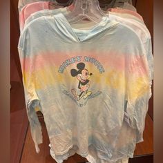 The Tie-Dye Is Such A Fun Look And Features A Pastel Blue, Pink, And Yellow Ombre Effect. The Soft Light Cotton Material Is Perfect For Spring Weather - Sunny Days, And Breezy Temps. Mickey Mouse Is Featured In Tie-Dye And “Mickey Mouse Classic & Original” Appears Around Him In A Light Blue Script. Size Large 100% Cotton Casual Pink Mickey Mouse Top, Spring Cotton Mickey Mouse Top, Spring Mickey Mouse Cotton Top, Casual Pink Minnie Mouse Top, Playful Pink Top For Disney Fan Events, Pink Long Sleeve Minnie Mouse Top, Mickey Mouse Cotton Hooded Top, Cotton Mickey Mouse Hooded Top, Casual Minnie Mouse Long Sleeve Hoodie