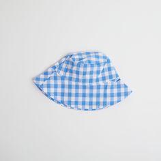 Introducing the Gingham Sunhat! Keep your little one looking stylish and shaded with this fun and fashionable cornflower blue baby sun hat, complete with checkered gingham print that your baby will love. Perfect for a day at the beach or a stylish stroll in the park. Shade in style! Fits ages 6 - 12 months Playful Blue Sun Hat For Summer, Playful Blue Wide-brim Sun Hat, Playful Blue Wide Brim Sun Hat, Playful Blue Sun Hat For Spring, Blue Summer Bucket Hat With Uv Protection, Summer Blue Bucket Hat With Uv Protection, Blue Bucket Hat With Uv Protection For Summer, Spring Blue Bucket Hat With Uv Protection, Summer Sun Hat With Uv Protection For Picnic