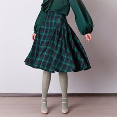 Black and green plaid skirt: - Hidden zipper on the back - Pleats - Classic tartan pattern - Fabric is 40% wool, 58% polyviscose, 2% of elastane Model is 6'2'', she wears US 8 size US 0  Bust 82 cm (32.5 inches) Waist 64 cm (25 inches) Hips 89 cm (35 inches) US 2  Bust 85 cm (33.5 inches) Waist 66 cm (26 inches) Hips 92 cm (36 inches) US 4  Bust 88 cm (34.5 inches) Waist 68 cm (27 inches) Hips 94 cm (37 inches) US 6  Bust 90 cm (35.5 inches) Waist 71 cm (28 inches) Hips 96 cm (38 inches) US 8  Bust 93 cm (36.5 inches) Waist 74 cm (29 inches) Hips 99 cm (39 inches) US 10  Bust 95 cm (37.5 inches) Waist 76 cm (30 inches) Hips 102 cm (40 inches) US 12  Bust 99 cm (39 inches) Waist 80 cm (31.5 inches) Hips 105 cm (41.5 inches) US 14  Bust 103 cm (40.5 inches) Waist 84 cm (33 inches) Hips 109 c Green Pleated Skirt For Fall, Fall Green Mini Skirt For Work, Green Skirted Skirt For Fall, Green Skirt For Fall, Green Fall Skirt, Green Knee-length Pleated Skirt For Workwear, Green Lined Mini Skirt For Fall, Knee-length Green Skirt For Fall, Green Knee-length Fall Skirt