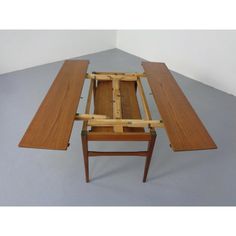 a table that has been made out of wood and is sitting on top of a gray floor