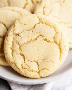 three cookies on a white plate next to each other