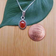 "Visit our on-line shop at: Etsy.com/shop/AlbuquerqueDesigns *sterling silver necklace pendant *Small pendant with silver box chain necklace 18\" *southwestern jewelry *carnelian / healing carnelian *calibrated pre-cut stones: 9x7mm oval shape *back of jewelry items are all covered / do not show the back of stones *all jewelry items are made to ship, slight variations in stones will occur comparing to pictures. *size of a penny is 19mm or a dime is 18mm in diameter for comparing size with jewelr Classic Silver Carnelian Jewelry, Silver Carnelian Round Pendant Jewelry, Stamped 925 Carnelian Jewelry, Silver Carnelian Cabochon Necklace, Carnelian Necklace, Box Chain Necklace, Southwestern Jewelry, Line Shopping, Silver Box