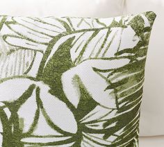 a green and white pillow sitting on top of a couch