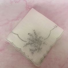 A beautiful, fancy vintage handkerchief with a detailed embroidery design featuring a stunning floral bouquets on each corner and scalloped trimmed edges. It is made of sheer white cotton. The silver tone under the white embroidery is the original embroidery guide often seen on this type of Appenzell and/or Swatow vintage embroidered linen. It measures 12" X 12". It is in good vintage condition with no tears, stains or other damage. Great for display among your boudoir collection. It also would Traditional Floral Embroidered Handkerchiefs As Gift, Vintage Embroidered Handkerchiefs For Wedding, Vintage Embroidered Wedding Handkerchiefs, Flower-shaped Embroidered Handkerchiefs For Gifts, White Floral Embroidered Handkerchiefs For Gifts, Flower Shaped Embroidered Handkerchiefs For Gift, Vintage Wedding Handkerchiefs With Machine Embroidery, Embroidered Flower Handkerchiefs For Gifts, White Floral Embroidery Handkerchiefs For Gift