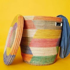 a colorful basket is sitting on a yellow background