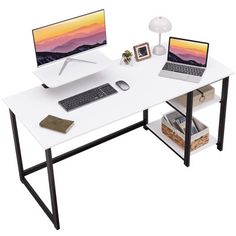 a computer desk with two laptops on it