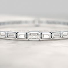 Unveil the brilliance with our 2 Carat Emerald Cut Diamond Tennis Bracelet. Each lab-grown diamond is meticulously set in 14K Yellow Gold, creating a mesmerizing symphony of sparkle. This handmade baguette tennis bracelet exudes timeless elegance, perfect for any special occasion. 𝐅𝐞𝐚𝐭𝐮𝐫𝐞𝐬:• 𝐌𝐚𝐝𝐞 𝐭𝐨 𝐎𝐫𝐝𝐞𝐫• 𝐌𝐞𝐭𝐚𝐥: 𝟏𝟎𝐊 𝐆𝐨𝐥𝐝 | 𝟏𝟒𝐊 𝐆𝐨𝐥𝐝 | 𝟏𝟖𝐊 𝐆𝐨𝐥𝐝• 𝐁𝐚𝐧𝐝 𝐂𝐨𝐥𝐨𝐫𝐬: Rose Gold, Yellow Gold & White Gold• 𝐁𝐫𝐚𝐜𝐞𝐥𝐞𝐭 𝐖𝐢𝐝𝐭𝐡: 5.00 MM• 𝐁𝐫𝐚𝐜𝐞 Modern Baguette Cut Diamond Bracelet For Anniversary, Elegant Emerald Cut Diamond Bracelet For Wedding, Elegant Emerald-cut Diamond Wedding Bracelet, Modern Baguette Cut Wedding Bracelet, Platinum Diamond Bracelet With Baguette Cut For Anniversary, Emerald Cut Diamond Tennis Bracelet For Wedding, Platinum Baguette Cut Diamond Bracelet For Anniversary, Luxury Baguette Cut Diamond Bracelet For Anniversary, Timeless White Gold Diamond Bracelet With Baguette Diamonds