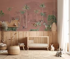 a baby's room decorated in pink and green with an animal theme on the wall