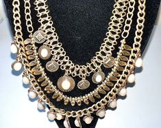 A large unbranded 90's grecian styled statement necklace  pre owend very good condition  in antigue gold tone  with multi drop link chains , designed to fit  in a water fall fashion  each chain embellished with a different style  attachment  wirth the botom chain having round pale pink crystals and cream cabochons  all attached to a single chain , with lobster clasp and extender  fantastic and eye-catching  drop. 31 cm  extender 8 cm weight 116 grams postage free Bohemian Multi-strand Double Chain Necklace, Bohemian Long Chain Layered Necklace, Bohemian Long Gold Chain Necklace, Bohemian Long Layered Chain Necklace, Bohemian Layered Chain Necklace, Metal Dangle Necklace With Chunky Chain, Metal Dangle Chain Necklace Costume Jewelry, Bohemian Double Chain Jewelry For Party, Bohemian Double Chain Necklace For Party