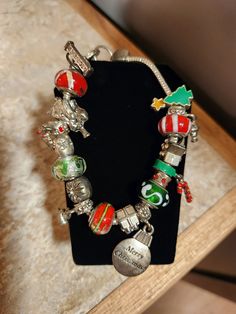 a bracelet with charms on it sitting on top of a table