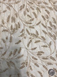 Distinguished by its luxurious design, this high-quality Khaki Sequins & Beads on Silk Chiffon JEC-176-3 Fabric is perfect for women's high-end evening dresses, costumes, jackets, and skirts. Our unique and distinctive fabric is available in a wide selection of colors. The fabric is sold by the Yard, and measures 44 inches in width. Elegant Embellished Embroidered Fabric, Elegant Beige Embroidered Fabric For Festive Occasions, Elegant Festive Pearl Embroidered Fabric, Elegant Formal Embroidered Fabric With Intricate Embroidery, Elegant Embellished Embroidered Fabric For Festive Season, Elegant Formal Festive Sequin Fabric, Elegant Intricate Embroidery Fabric For Evening, Elegant Festive Embroidered Georgette Fabric, Elegant Embroidered Fabric With Pearl Embroidery For Reception