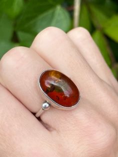 Vintage sterling silver ring with Baltic amber, UK size L 1/2, US 6. Stone size 17mm x 12mm. Classic Orange Rings With Polished Finish, Sterling Silver Oval Cabochon Opal Ring, Classic Amber Ring With Polished Finish, Oval Baltic Amber Ring In Amber, Oval Baltic Amber Rings In Amber Color, Oval Cabochon Dome Ring With Polished Finish As Gift, Oval Baltic Amber Ring, Classic Orange Oval Cabochon Rings, Gift Dome Ring With Oval Cabochon And Polished Finish