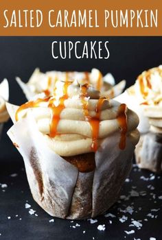 salted caramel pumpkin cupcakes on a black surface with text overlay that reads salted caramel pumpkin cupcakes