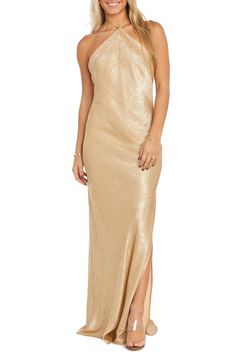 Stay golden in this sleek shimmery gown designed in a halter silhouette with a stem-showing side slit. 55" center front length (size Medium) Slips on over head Halter neck Side slit Lined 100% polyester Hand wash, dry flat Imported Gold Halterneck Satin Dress, Gold Sequin Halter Dress, Gold Fitted Halter Evening Dress, Luxury Fitted Floor-length Halter Dress, Gold Shimmer Floor-length Dress, Gold Long Dress, Gold Dresses Long, Gold Formal Dress, Morgan Dress