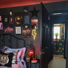 a bed room with a neatly made bed and pictures on the wall next to it