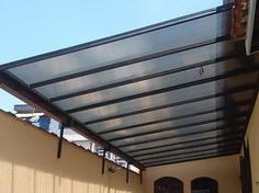 an outdoor covered patio area with sliding doors