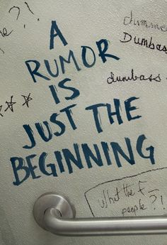 a toilet paper dispenser with writing on the wall next to it that says, a rumor is just the beginning