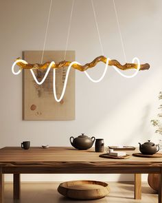 a wooden table with some lights hanging from it's sides and two teapots on the other side