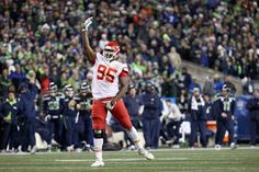 a football player holding his arm up in the air