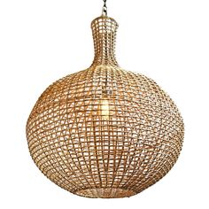 a light that is made out of wood and has a wire ball hanging from the ceiling