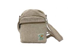 This Hemp Shoulder bag is handmade in Nepal. It is made up of natural hemp fiber with a mix of cotton. An important feature of this crossbody bag is eco-friendly and bio-degradable. With an adjustable strap, it is very comfortable and safe to wear while traveling. Size: 20cm (L) x 18cm (W) Material: 50% Hemp and 50% Cotton Eco-friendly Cream Jute Shoulder Bag, Eco-friendly Shoulder Bag With Adjustable Strap, Eco-friendly Cream Shoulder Bag, Casual Beige Fair Trade Shoulder Bag, Casual Hemp Bags For Daily Use, Eco-friendly Fair Trade Shoulder Bag For Daily Use, Eco-friendly Canvas Shoulder Bag, Eco-friendly Hemp Bag In Natural Color, Eco-friendly Fair Trade Shoulder Bag For Travel