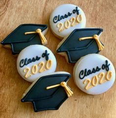 three decorated cookies with graduation caps and tassels on them that say class of 205