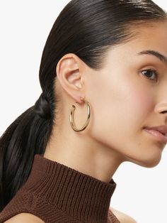 You can never go wrong with this pair of gold hoop earrings with a high-polish texture and hypoallergenic titanium posts. Carefully crafted and dipped in 14k gold, these classic gold hoops are meant to be worn every single day by a confident and chic woman. Score bonus styling points by pairing these gold hoop earrings with a thin gold collar. • Versatile & timeless gold hoops• Coated with a thick 14k gold layer & feature hypoallergenic titanium posts • Comfortable to wear all day long 14k Gold Hoop Earrings, Round Earring, Detailed Jewelry, Gold Collar, Classic Gold, Letter Necklace, Silver Pieces, Gold Hoops, Round Earrings