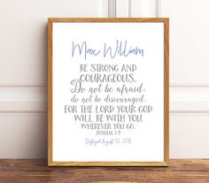 a wooden frame with a bible verse in blue and purple on the bottom, next to a white wall