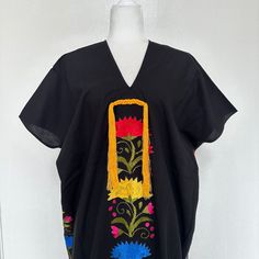 This hand-woven two panel Mexican Yalalag Hupil long tunic is a VINTAGE CLASSIC with flowers embroidered by hand by artisans of Oaxaca 100% handmade. A relaxed style and at the same time looks very elegant for a party in the morning or afternoon. It is made of 100% cotton blanket fabric. MADE IN MEXICOBy: Mexican ArtisansFor: Women Size: M/L Color: black | multi Length: 41.5" Details: Material: cotton silk Non-stretch Embroidered thread Front & back tassels Ankle Length Washing Instructions: Ple Traditional Floral Embroidered Festival Tunic, Traditional Floral Embroidered Tunic For Festival, Folk Kaftan With Floral Embroidery For Traditional Ceremonies, Folk Style Kaftan With Floral Embroidery For Ceremonies, Traditional Tunic For Spring, Traditional Free Size Tunic For Spring, Folk Style Cotton Kaftan With Floral Embroidery, Traditional Floral Embroidered Short Sleeve Tunic, Traditional Floral Embroidery Tunic With Short Sleeves