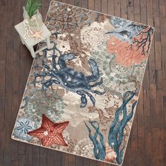 a rug with an octopus, starfish and corals on it next to a chair