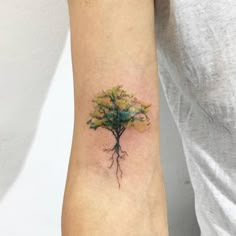 a small tree tattoo on the left arm