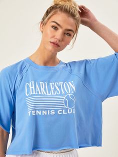 This Charleston inspired tee features a tennis club graphic for a coastal look that adds a sporty flare to your fit on and off the court. The boxy fit, oversized sleeves, and raw hem create a flowy, effortless look that stays light layered over a tennis dress to complete the look. Oversized Sleeves, Oversize Sleeves, Tennis Club, Tennis Clubs, Skirts With Boots, Spandex Shorts, Comfy Tops, Tennis Dress, Active Women