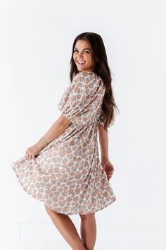 Features Square Neck Puffy Sleeve Above Elbow Lined Dress Elastic Waist Pockets 100% Polyester Lining & 100% Polyester Knee Length Dress White Dress with Tan & Green Flowers Size + Fit XS 00-2 Small 2-6, Medium 8-10, Large 12-14, X-Large 14-16, 2X 20-22, 3X 24-26 Kristin is 5'4", a size 1 and is wearing a Small Ashley is 5'6" a size 18 and is wearing a 2X Runs true to size. Measurements taken while laying flat and then doubled. They do no account for stretch. Click here for shoes Size Bra Band L Feminine Bow Print Spring Dresses, Feminine Spring Dresses With Bow Print, Flowy Floral Print Dress With Puff Sleeves, Spring Bow Print Mini Dresses, Floral Print Puff Sleeve Dress For Daywear, Beige Puff Sleeve Dress With Ruffle Hem, Beige Dresses With Ruffle Hem And Puff Sleeves, Beige Dress With Ruffle Hem And Puff Sleeves, Beige Dress With Puff Sleeves And Ruffle Hem