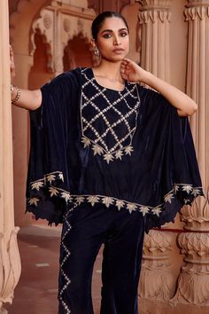 Navy blue cape with floral aari embroidery and cutwork hem. Paired with embroidered flared pant.
Component: 2
Pattern: Embroidered
Type Of Work: Aari
Neckline: Round
Sleeve Type: Split
Fabric: Velvet
Color: Blue
Other Details: 
Cutwork border
Occasion: Sangeet - Aza Fashions Traditional Festive Cape Sets, Traditional Festive Palazzo Set With Cape, Cape Sleeves Palazzo Set With Dupatta, Palazzo Set With Cape Sleeves And Dupatta, Embroidered Festival Sets With Cape Sleeves, Festival Embroidered Sets With Cape Sleeves, Eid Dupatta With Cape Sleeves, Traditional Embroidered Palazzo Set With Cape Sleeves, Traditional Palazzo Set With Floral Embroidery And Cape Sleeves