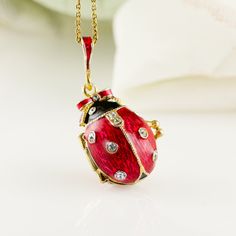 "Bright and festive ladybug locket with heart surprise inside, enameled over solid sterling silver, designed and made in our NJ shop in the tradition of Faberge jewelry. The egg shaped locket ladybug with bright purple wings and a black head, will open to show the red heart inside the locket, steadily fixed in its place. Clear Swarovski crystals are set in the center of the heart, as well as in the dots of the bug and its eyes. The locket is almost 1\"(25 mm) long. You will receive the pendant r Oval Enamel Locket Jewelry, Enamel Locket Jewelry For Anniversary, Red Enamel Jewelry For Anniversary, Enamel Jewelry As A Gift For Her, Elegant Enamel Jewelry With Lobster Clasp, Enamel Jewelry As Gift For Her, Elegant Enamel Jewelry As Gift For Her, Red Enamel Jewelry With Charms, Elegant Enamel Jewelry Keepsake