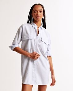 Elevate your wardrobe with the Abercrombie & Fitch Women's Oxford Mini Shirt Dress, a blend of classic style and modern comfort. This chic piece is perfect for any casual occasion or a smart-casual office setting.

- **Size**: M Petite
- **Color**: Blue Stripe
- **Material**: Cotton, Polyester
- **Gender**: Female
- **Features**: Functional button-through detail, chest pockets with flap closure, classic collar

Crafted from a premium mix of cotton and polyester, this dress offers both durability Collared Shirt Dress With Buttoned Pockets For Work, Classic Shirt Dress With Pockets And Spread Collar, Classic Shirt Dress With Spread Collar And Pockets, Spring Button-up Shirt Dress With Pockets, Spring Shirt Dress With Buttoned Pockets And Relaxed Fit, Blue Collared Shirt Dress With Pockets, Collared Cotton Shirt Dress With Button Closure, Button-up Shirt Dress With Pockets For Daywear, Collared Shirt Dress For Work With Pockets