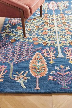 a blue rug with colorful trees on it