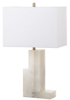 a white table lamp with a gold base and a square shade on the top,