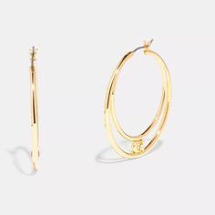 These Sleek Double Hoop Earrings Feature Our Signature Accented With A Sparkling Crystal Stud. The Modern Design Is A Perfect Pick For Day Or Night. Product Details: Gold Tone Plated Brass Hypoallergenic Titanium Post Clutch Closure 1 1/2" (L) X 1 1/2" (H) Style No. C9356 Coach Round Jewelry For Anniversary, Modern Metal Open Circle Hoop Earrings, Everyday Gold Coach Jewelry, Everyday Silver Coach Jewelry, Metal Hoop Earrings With Ear Wire For Anniversary, Modern Metal Hoop Earrings For Anniversary, Metal Hoop Earrings For Anniversary, Modern Circular Hoop Earrings For Anniversary, Modern Hoop Earrings For Anniversary