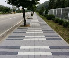 there is a sidewalk that has been designed to look like checkered tiles on the ground