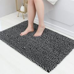 a woman is sitting on the edge of a bathtub with her feet in the tub